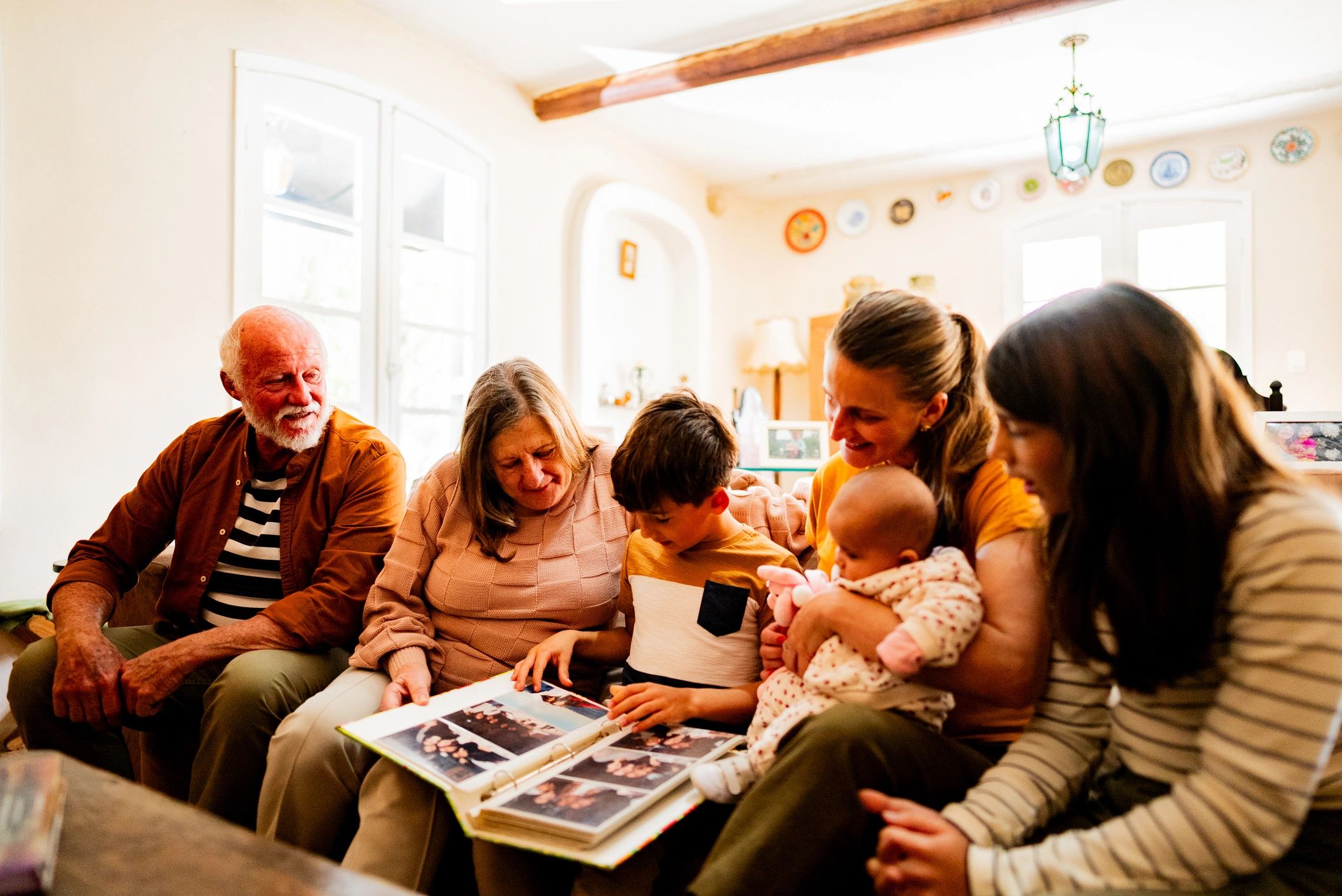 Family looking at a photo album together at home