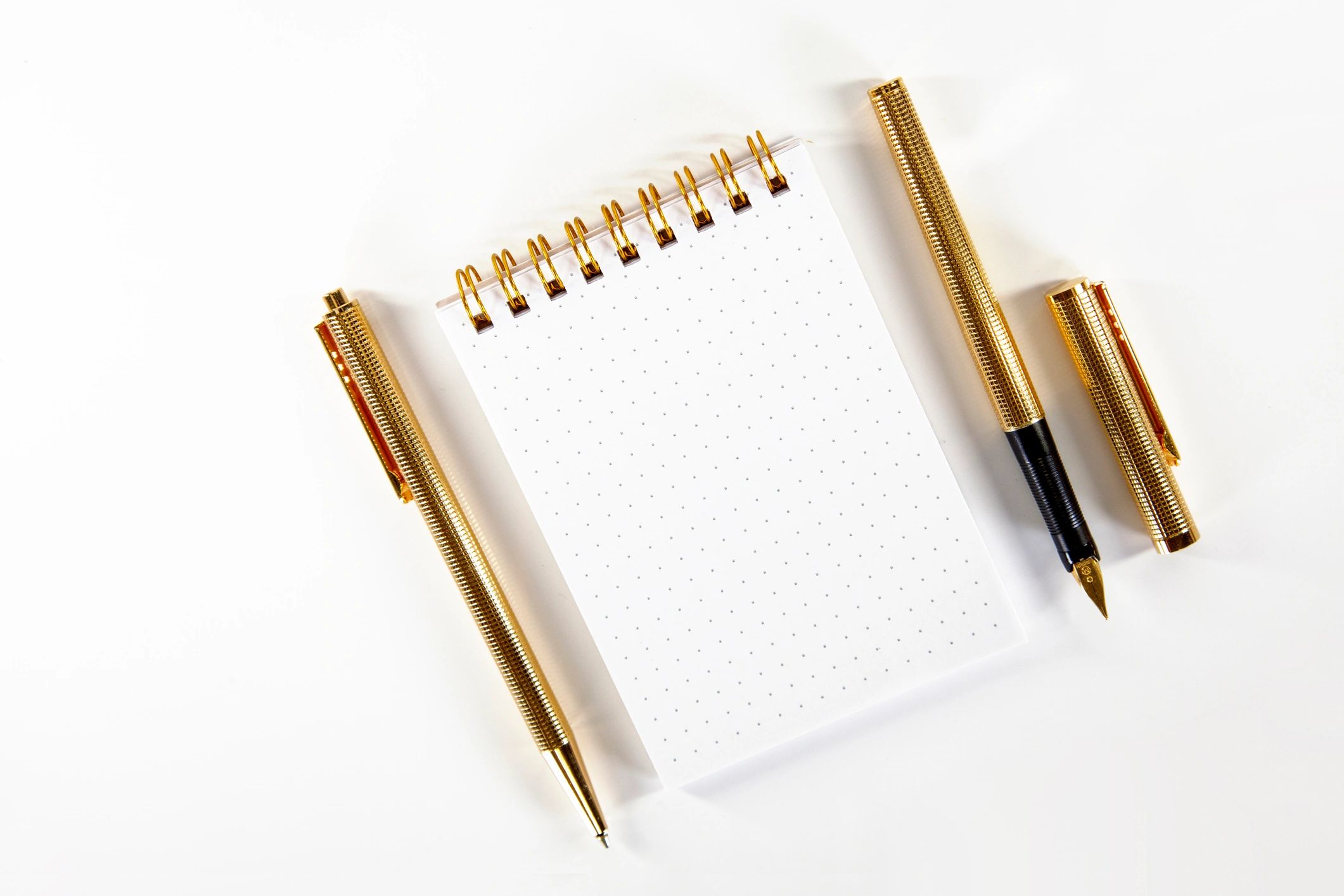 Blank notebook with pens for writing prompts
